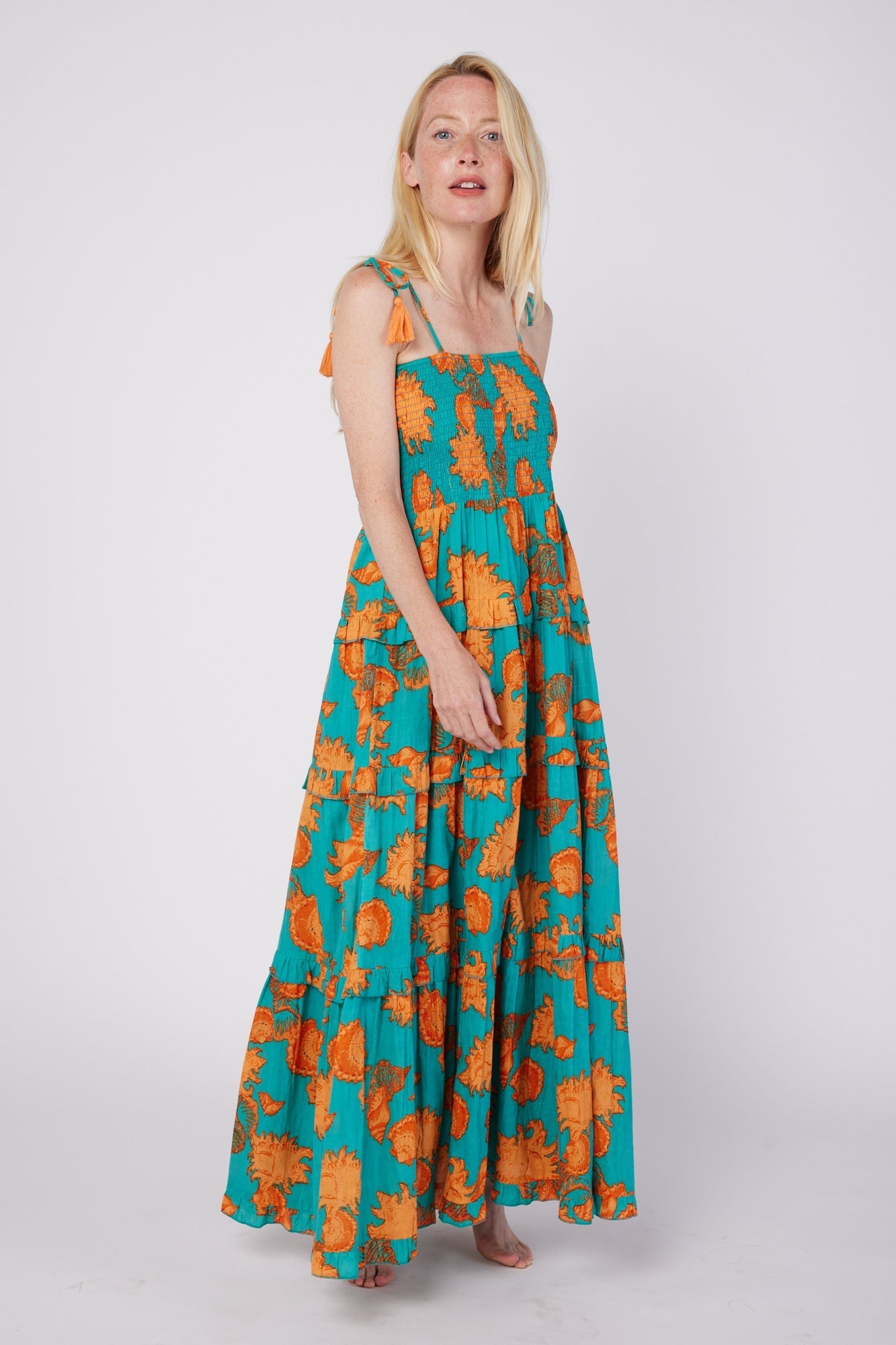 ModaPosa Dianora Spaghetti Strap Smocked Tiered Maxi Dress in Turquoise Orange Shells . Discover women's resort dresses and lifestyle clothing inspired by the Mediterranean. Free worldwide shipping available!