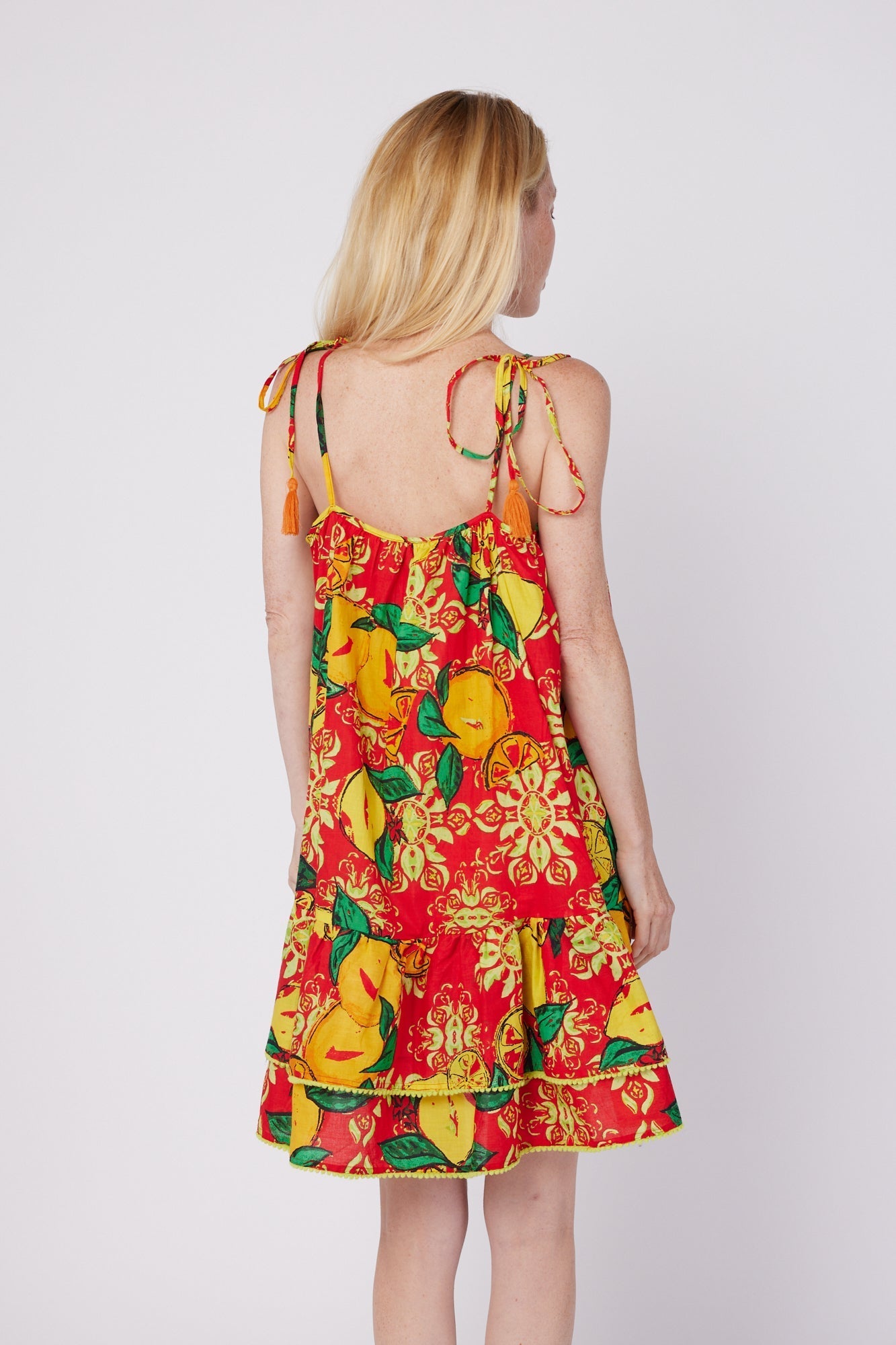 ModaPosa Tonia Sleeveless Spaghetti Strap Ruffle Mini Dress with Pom Pom Trim in Red Citrus Majolica . Discover women's resort dresses and lifestyle clothing inspired by the Mediterranean. Free worldwide shipping available!