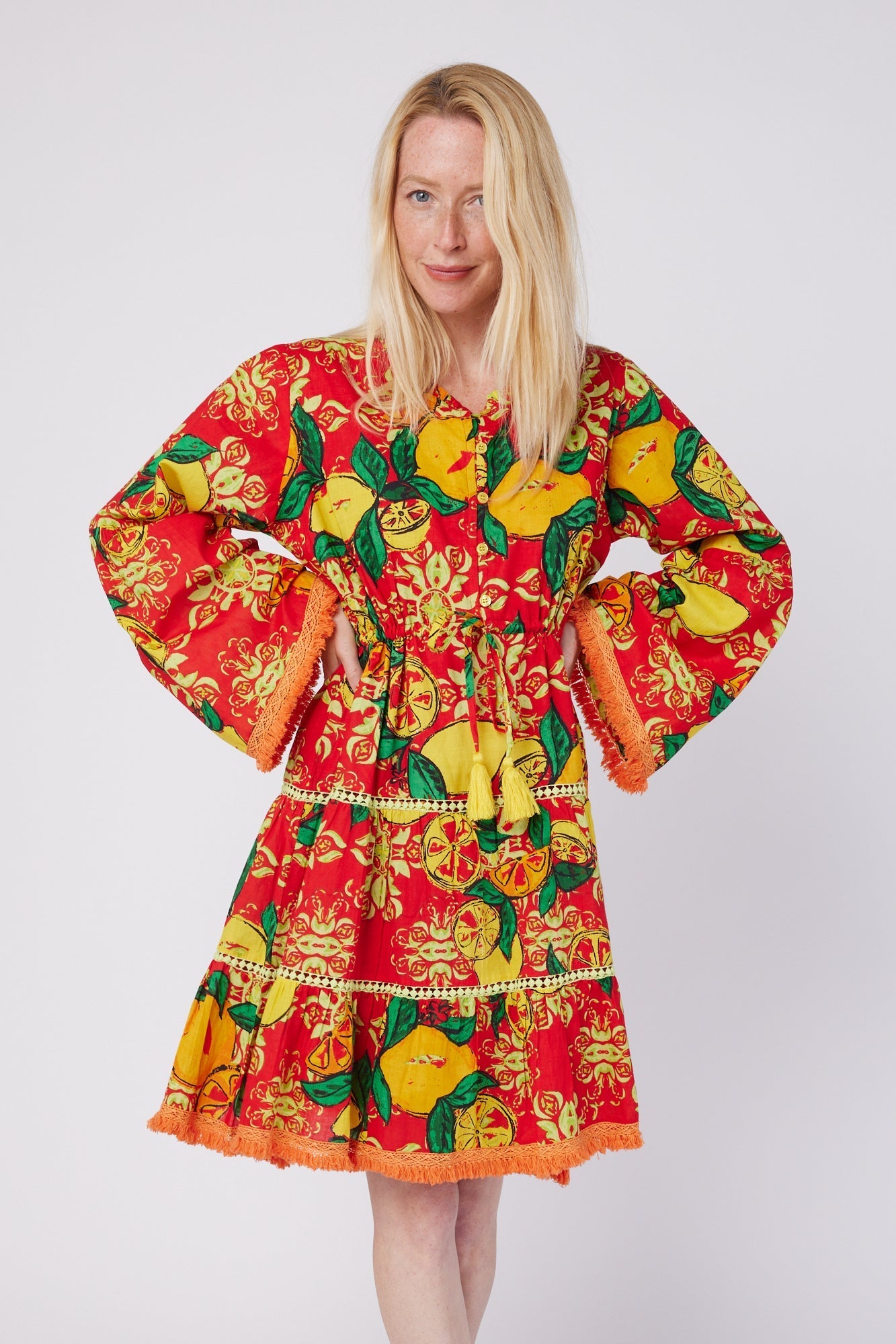 ModaPosa Desideria Wide Bell Sleeve Drawstring Empire Knee Length Dress in Red Citrus Majolica . Discover women's resort dresses and lifestyle clothing inspired by the Mediterranean. Free worldwide shipping available!