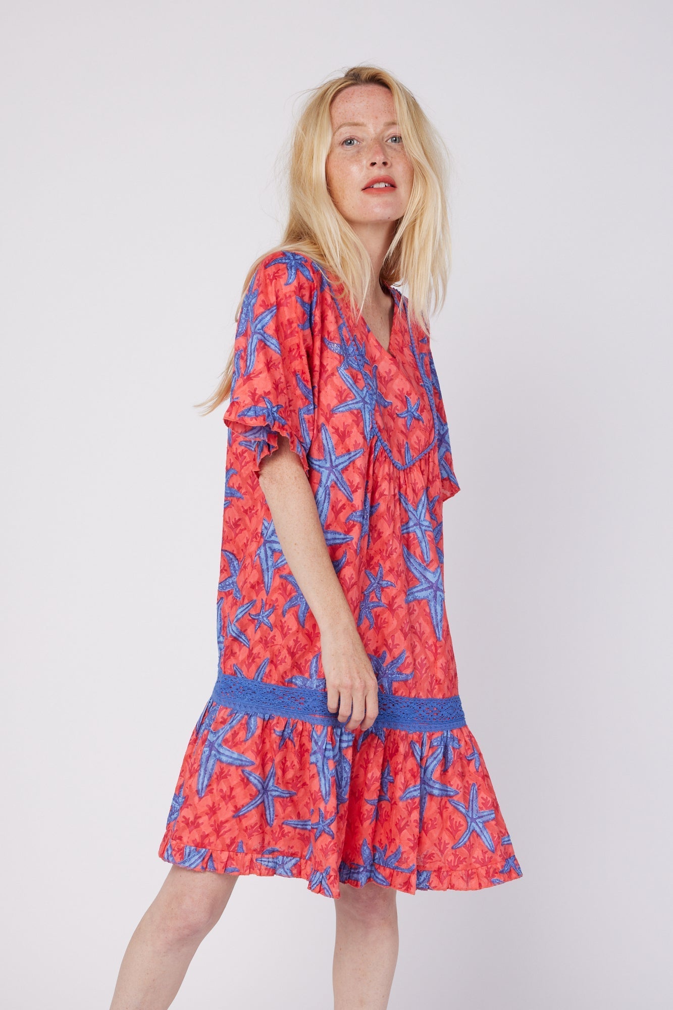 ModaPosa Ilaria Short Sleeve Drop Waist Hand Embroidered Knee Length Dress with Lace Trim in Starfish Scales . Discover women's resort dresses and lifestyle clothing inspired by the Mediterranean. Free worldwide shipping available!