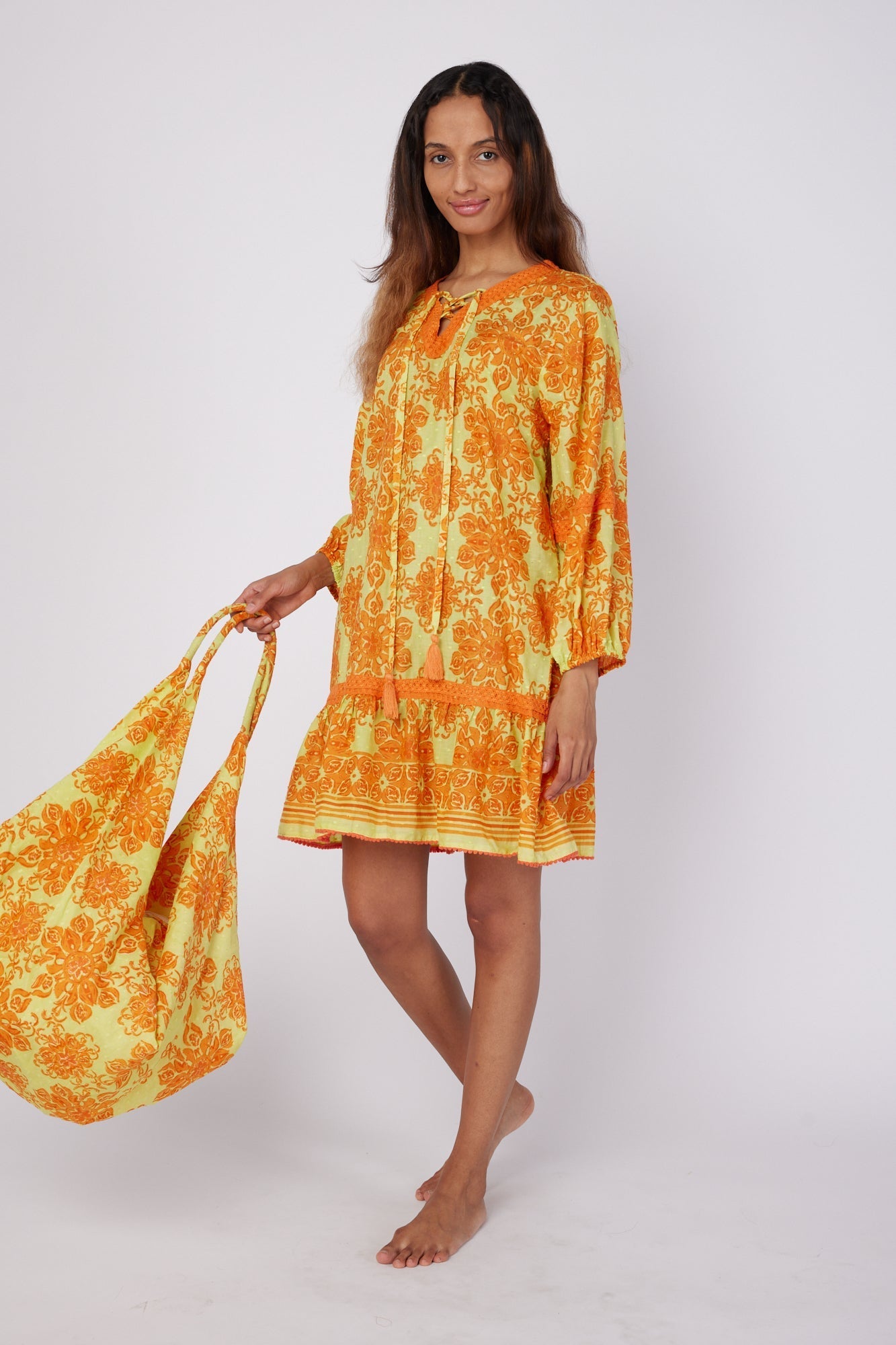 ModaPosa Ilaria Puff Sleeve Drop Waist Hand Embroidered Knee Length Dress with Lace Trim in Curacao Majolica . Discover women's resort dresses and lifestyle clothing inspired by the Mediterranean. Free worldwide shipping available!
